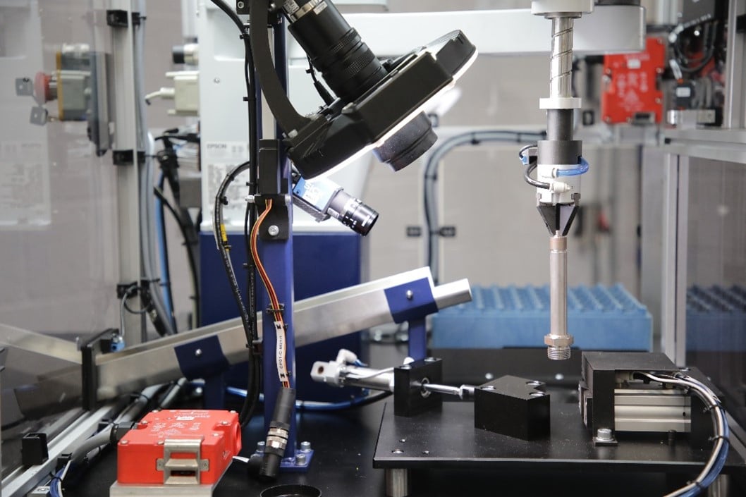 Inspection system featuring robotic arm and camera