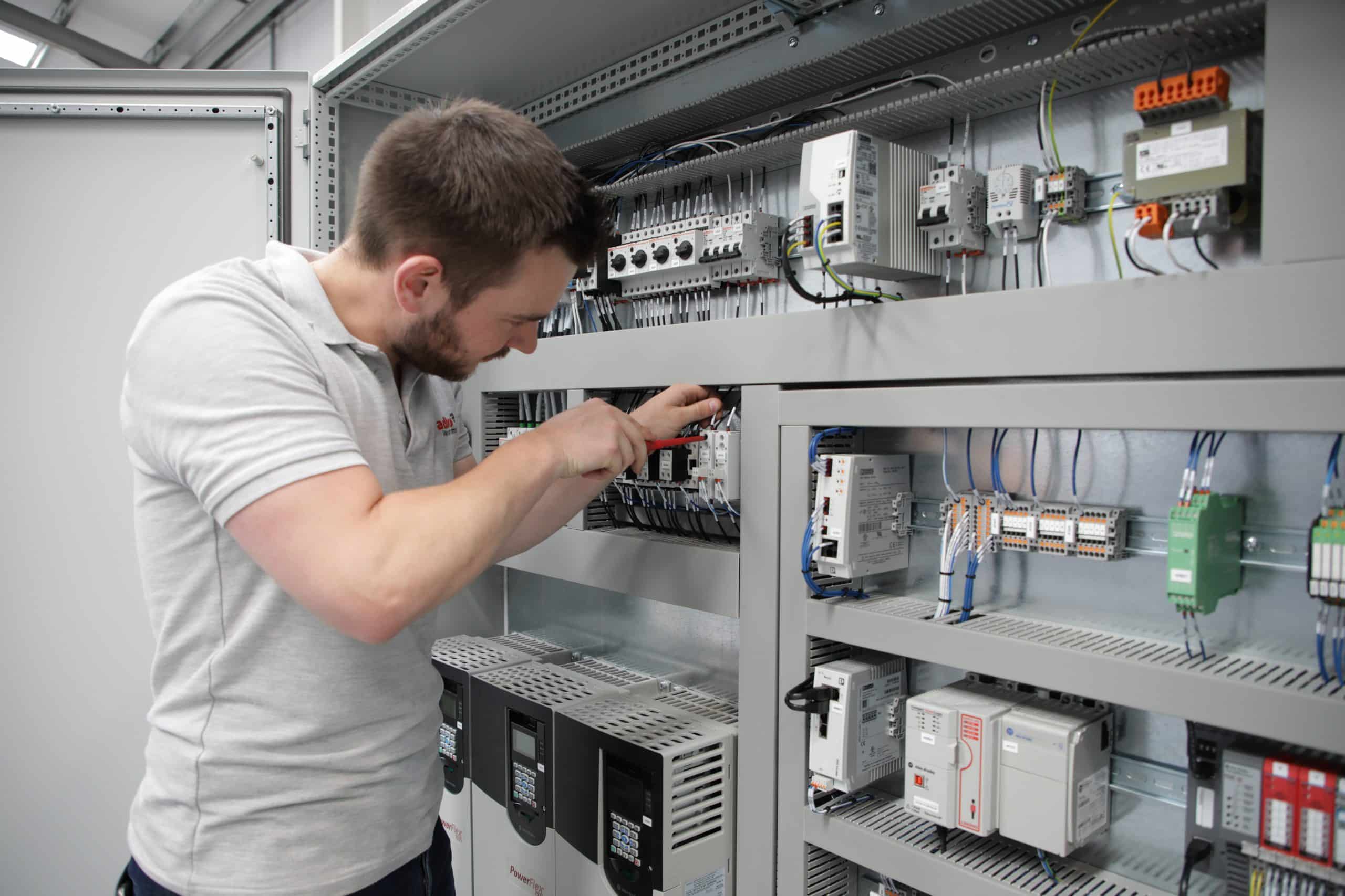 An engineer from adbro controls installing components in a control panel